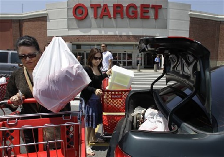 Shoppers Joselin Pena, left, and her niece Ingrid Romero, center, both of Boston, load packages into their car after shopping at a Target location, in Boston.